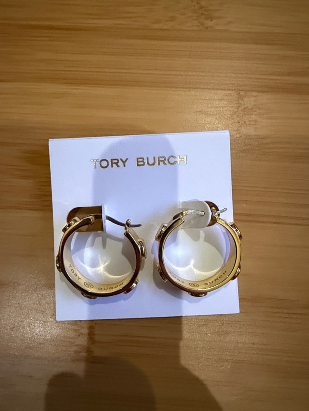 Tory Burch Gold toned Logo Hoop Earrings